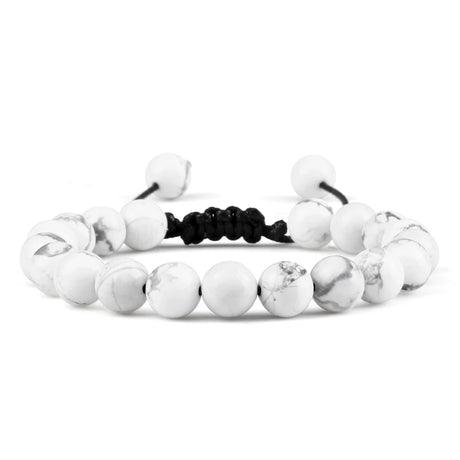 White beaded bracelet with black cord on a white background