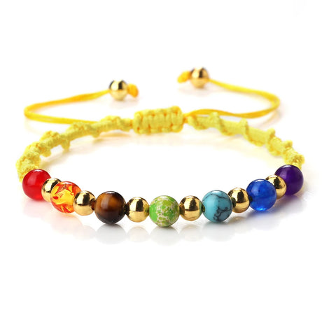 Colorful beaded bracelet with a yellow cord on a white background