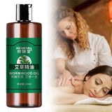 Bottle of wormwood oil with a woman receiving a massage in the background
