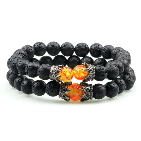 Black beaded bracelet with fiery orange beads on a white background