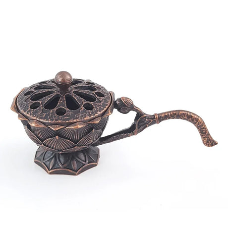 Decorative bronze incense burner with intricate design on a white background