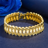 Gold bracelet on a dark blue fabric background