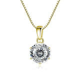 Gold pendant with a large diamond on a white background