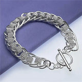Silver braided bracelet on a purple and white background