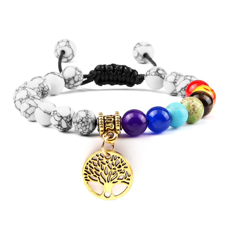 Multicolored beaded bracelet with a gold tree of life charm on a white background