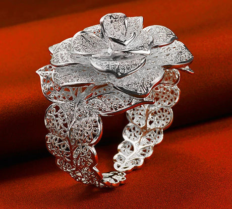 Silver floral ring on a red background with 'BABY' brand name.