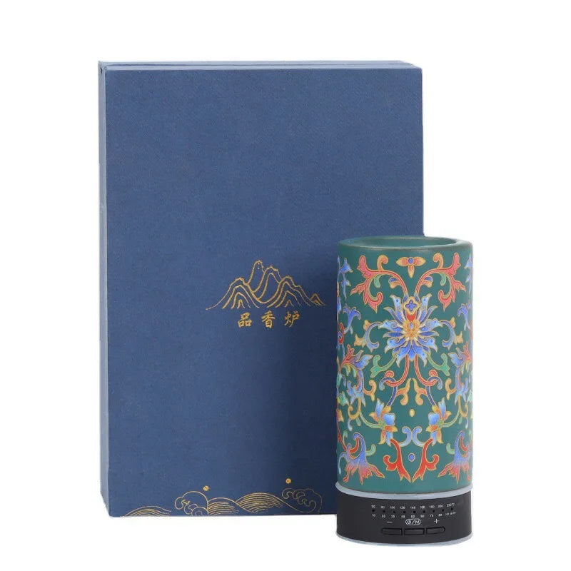 Decorative cylindrical product with floral patterns next to a blue box with gold text