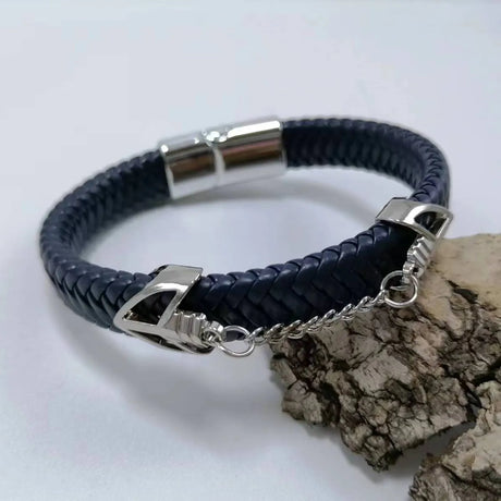 Navy braided leather bracelet with silver clasp on a light gray background