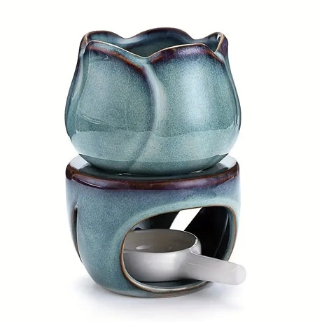 Blue ceramic oil burner with a small white dish on a white background