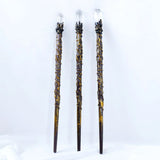 Three decorative sticks with crystal tops on a white background