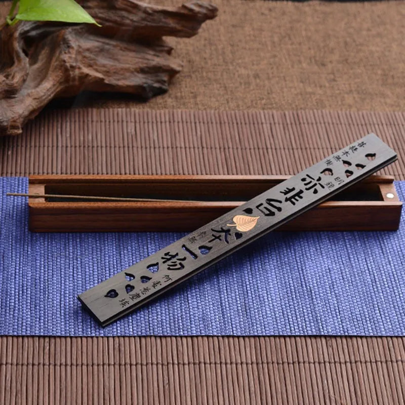 Incense holder with incense sticks on a blue mat with wooden elements