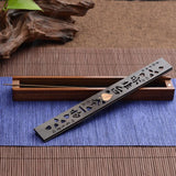Incense holder with incense sticks on a blue mat with wooden elements