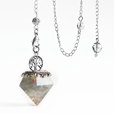 Necklace with a crystal pendant and tree of life symbol on a white background