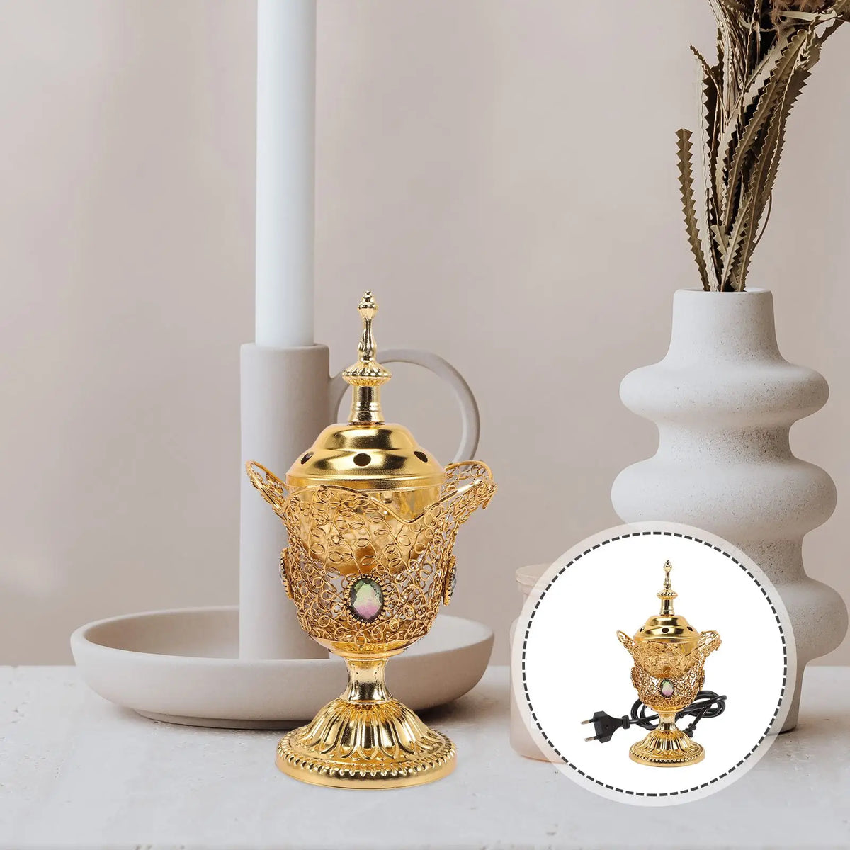 Decorative gold teapot with intricate designs on a neutral background