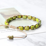Necklace with green beads on a white surface