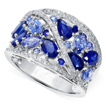 Ring with blue gemstones and diamond accents on a white background