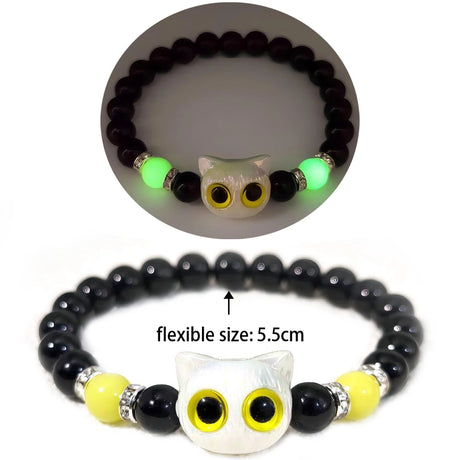 Black beaded bracelet with owl design and glowing green feature, on a white background.