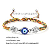 Colorful braided bracelet with evil eye and hamsa hand charm on a white background