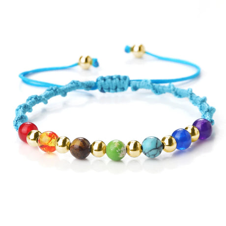 Colorful beaded bracelet with blue cord on a white background