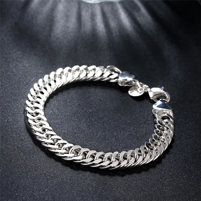 Silver chain bracelet on a dark textured surface