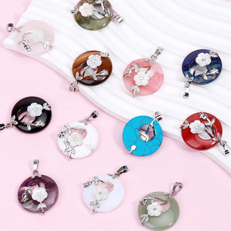 Assorted colorful pendants with floral designs on a pink background