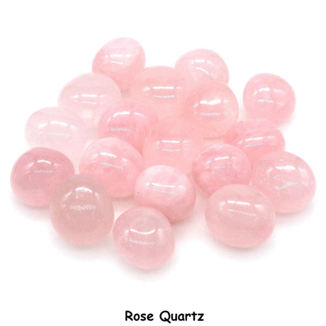 Pink rose quartz stones on a white background