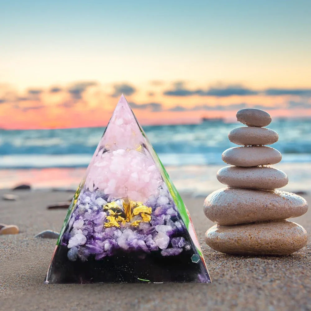 Decorative pyramid with crystals on a beach at sunset