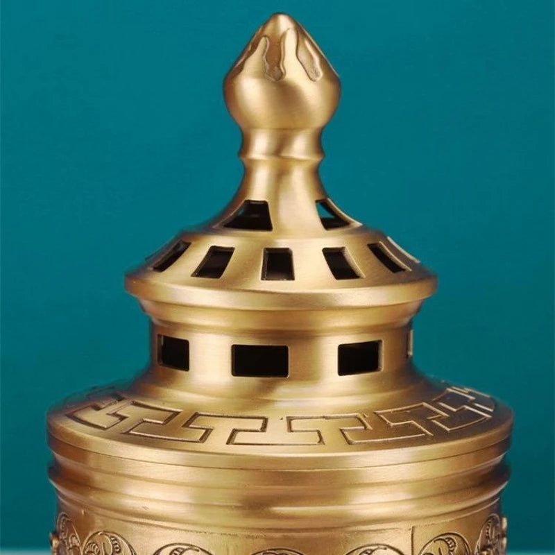 Bronze incense burner with intricate design on a teal background