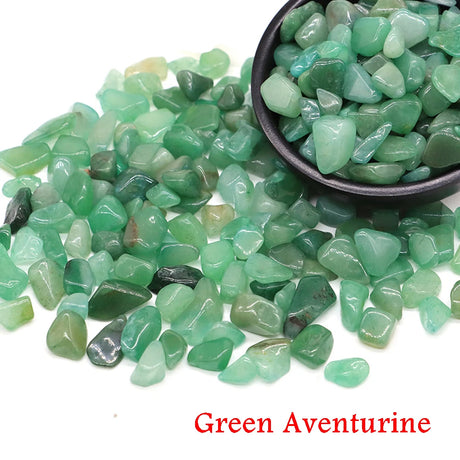 Green aventurine stones with a bowl on a white background