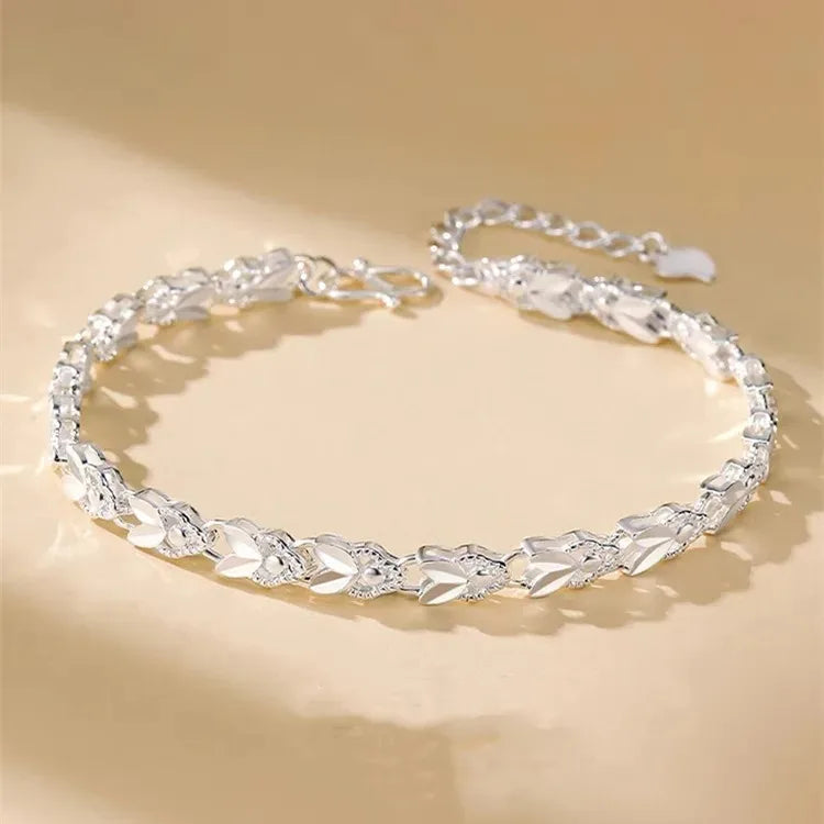 Silver choker necklace on a beige background