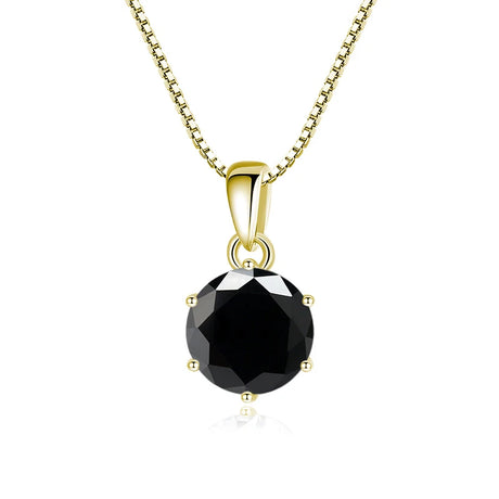 Gold pendant with a black gemstone on a white background