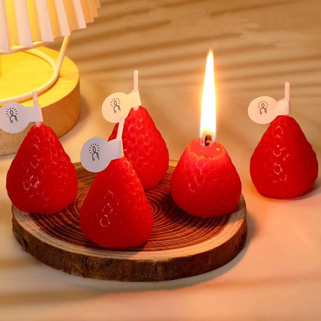 Red pear-shaped candles on a wooden base with a blurred background