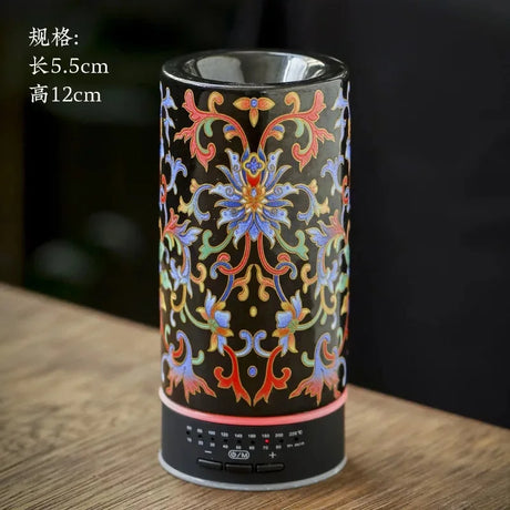 Decorative cylindrical object with colorful patterns on a wooden surface