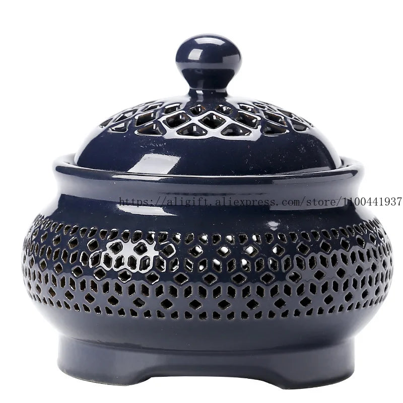 Navy blue ceramic incense burner with intricate design on a white background