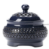 Navy blue ceramic incense burner with intricate design on a white background