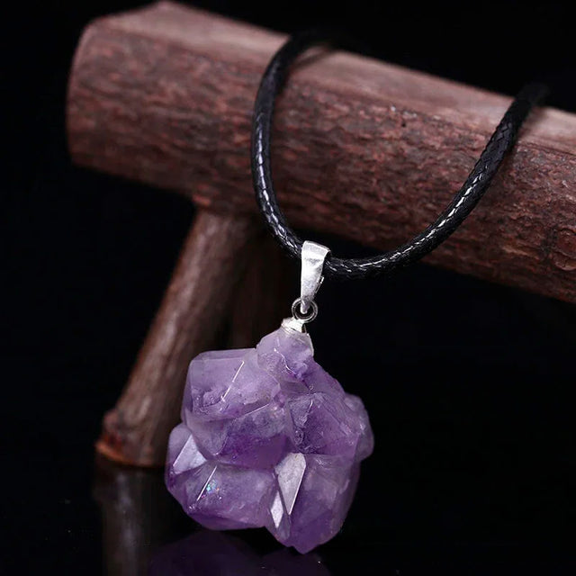 Amethyst crystal necklace on a dark background