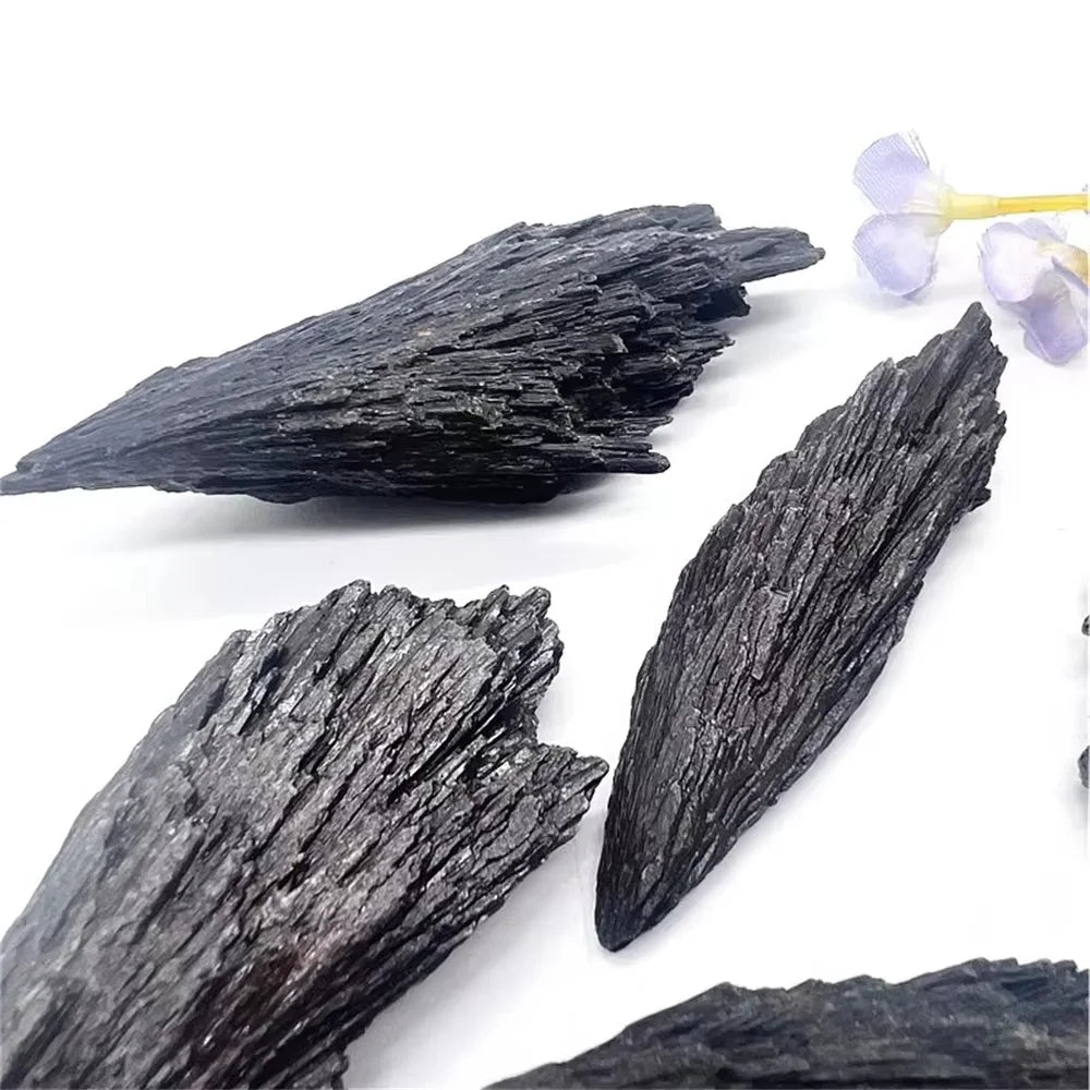 Blackened wood pieces on a white background with small flowers.