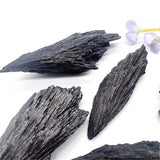 Blackened wood pieces on a white background with small flowers.
