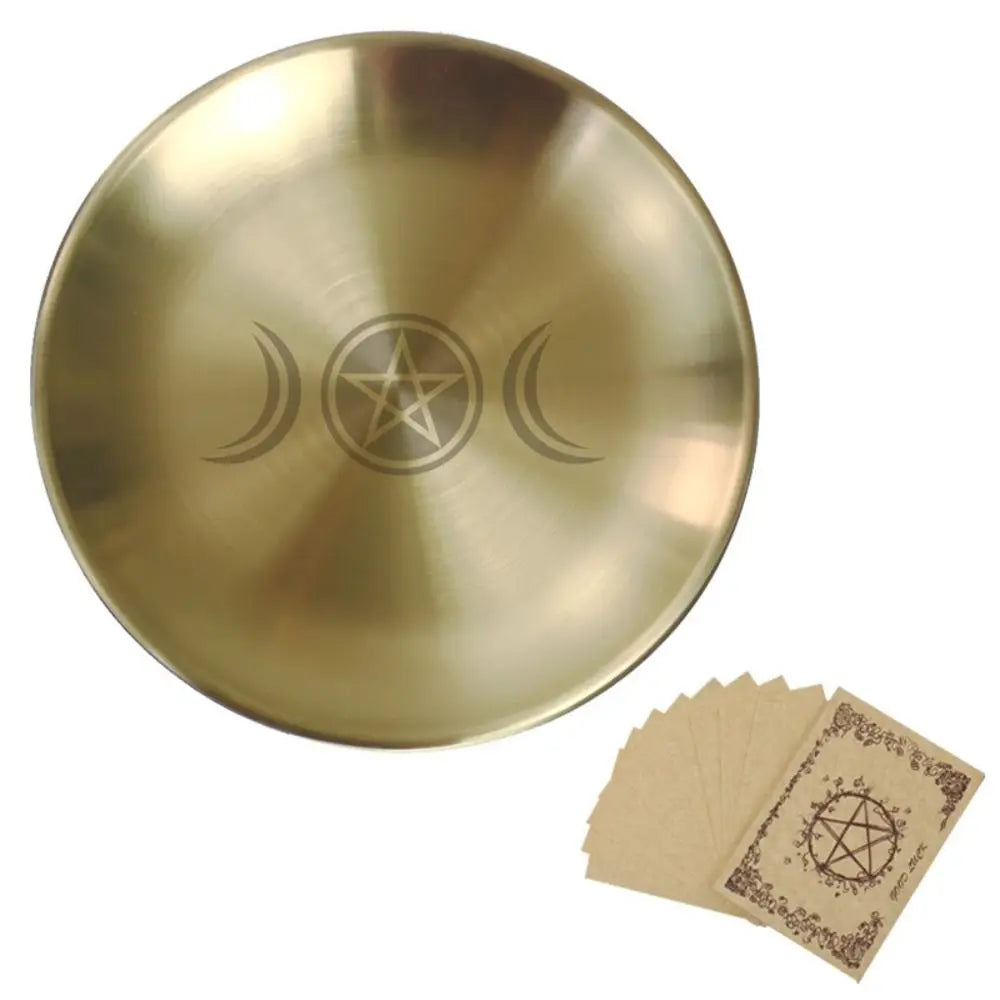 Gold tibetan singing bowl with pentacle and moon designs, accompanied by brown cards with similar designs.