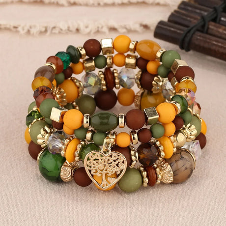 Set of colorful beaded bracelets with gold accents on a beige surface