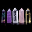 Set of five crystal towers in different colors on a black background