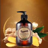 Essence oil bottle with ginger root and leaves on a warm brown background