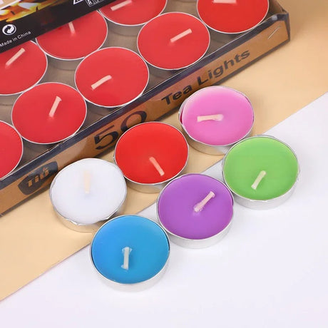 Colorful tea light candles in front of a box labeled '50 Tea Lights'.