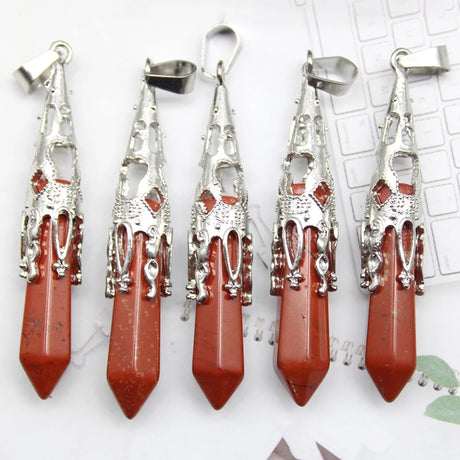 Five red stone pendants with silver tops on a white background