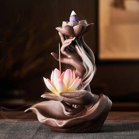 Ceramic incense burner with lotus design on a dark surface