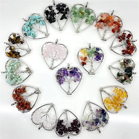 Collection of heart-shaped crystal pendants with various colored stones on a white background