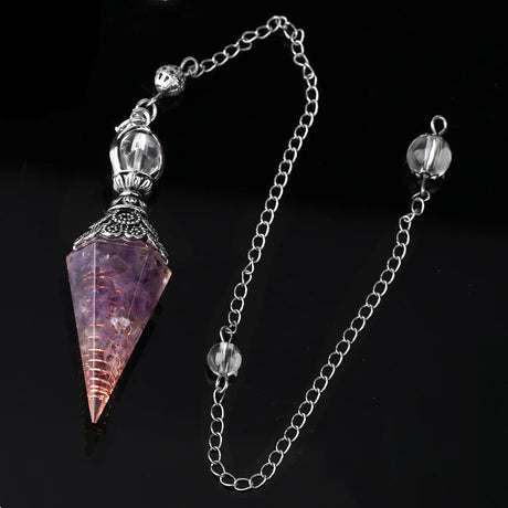 Crystal pendulum with chain on a black background