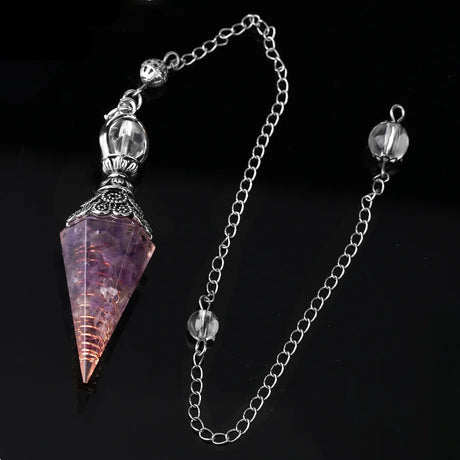 Crystal pendulum with chain on a black background