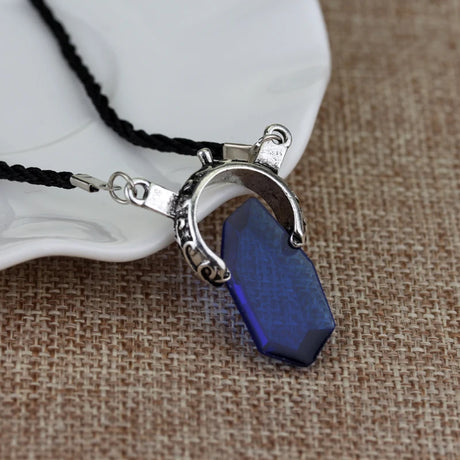 Necklace with a blue pendant on a textured surface