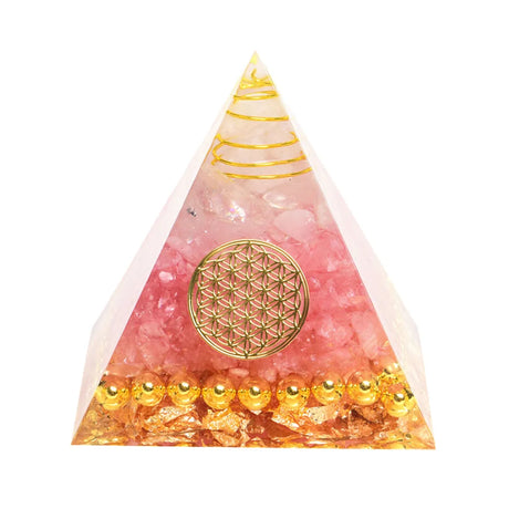 Pyramid-shaped object with pink and gold design on a white background